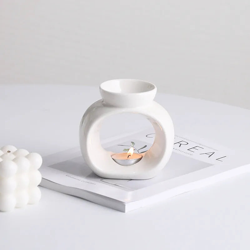 White retro Nordic ceramic aromatherapy stove ornament on a surface.