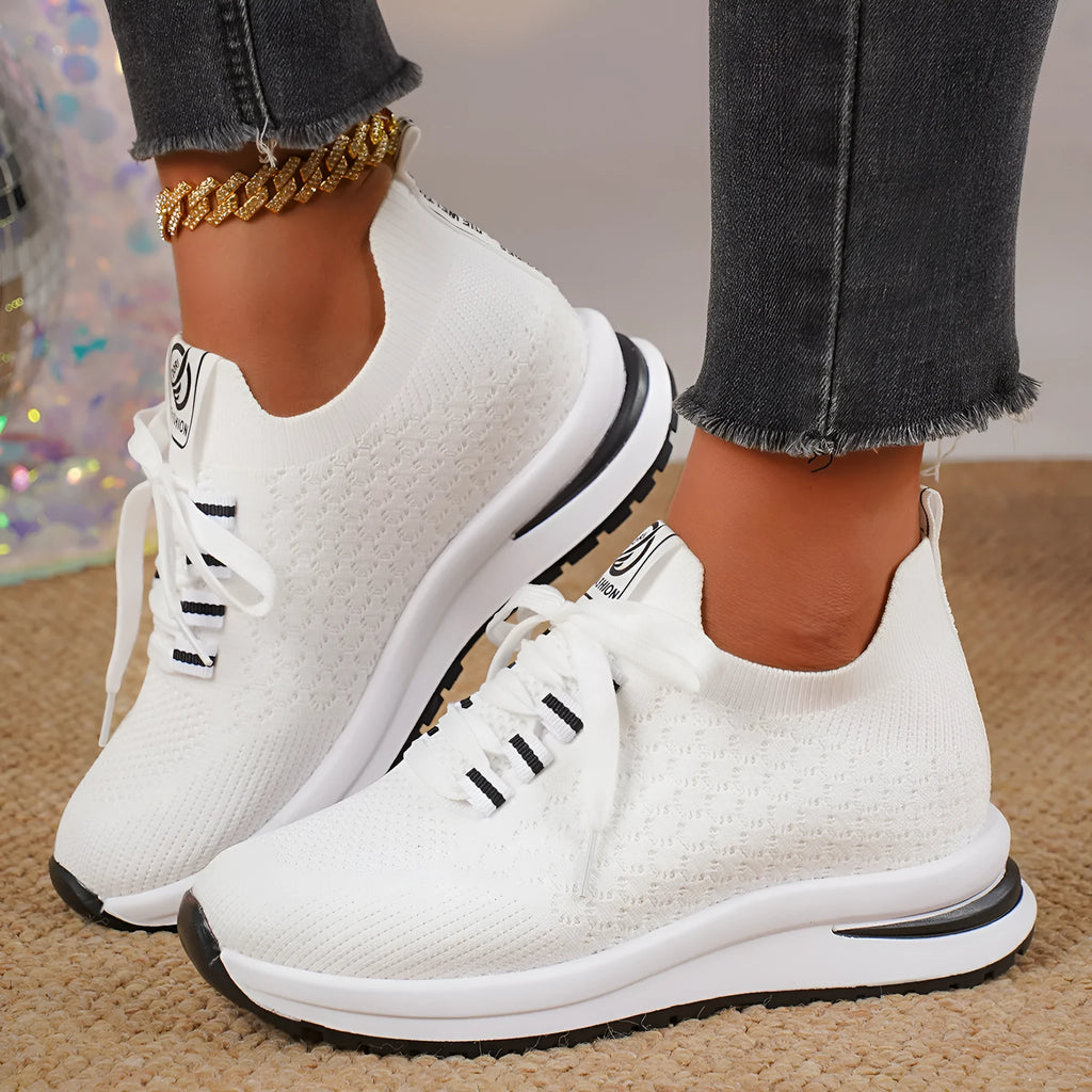 Women's black and white mesh lace-up flat pumps with a round toe and rubber sole.