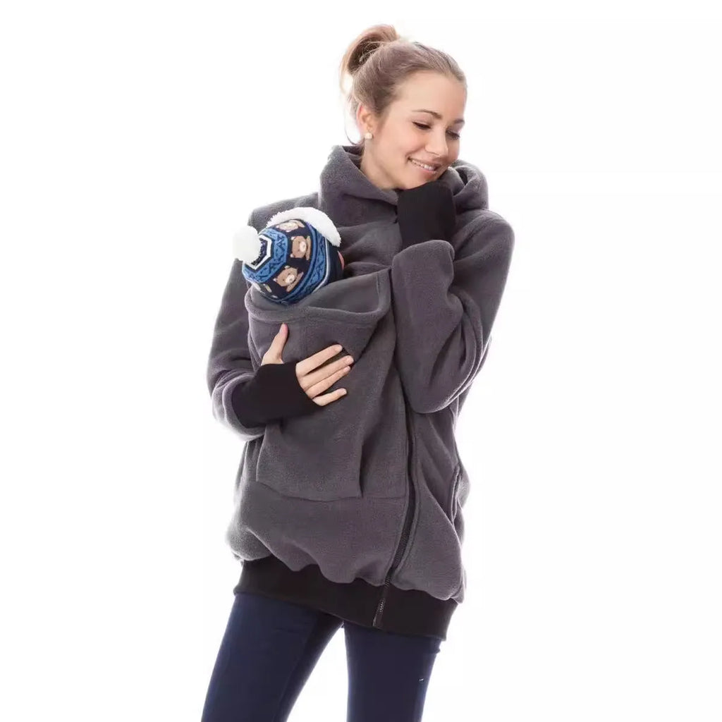Red loose-fit polar fleece women's sweater with long sleeves on a hanger.