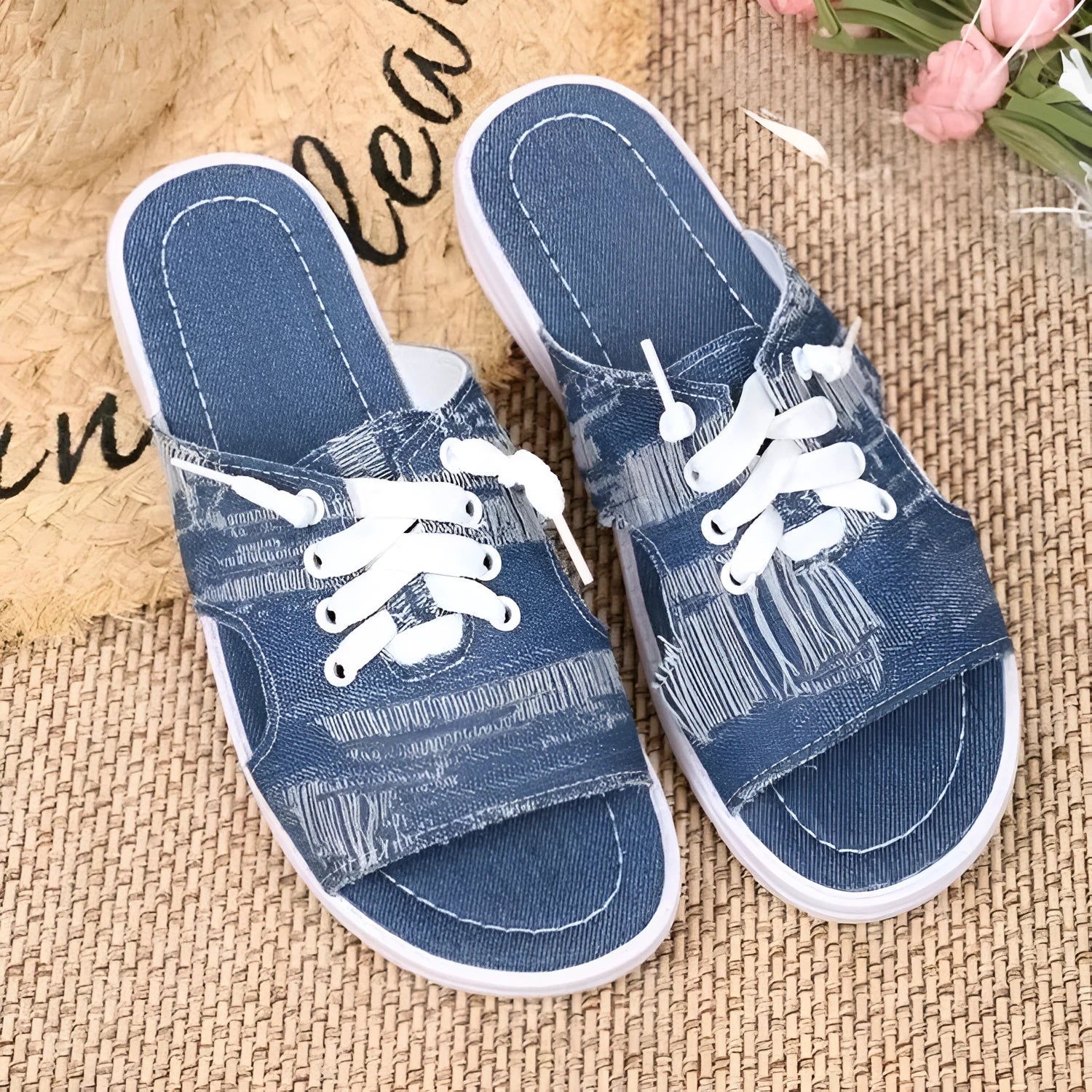 Blue women's Roman style flat canvas slippers with a rubber sole.