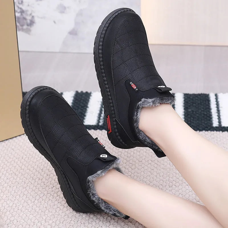 Women's black flat casual ankle boots with round toe and synthetic leather upper