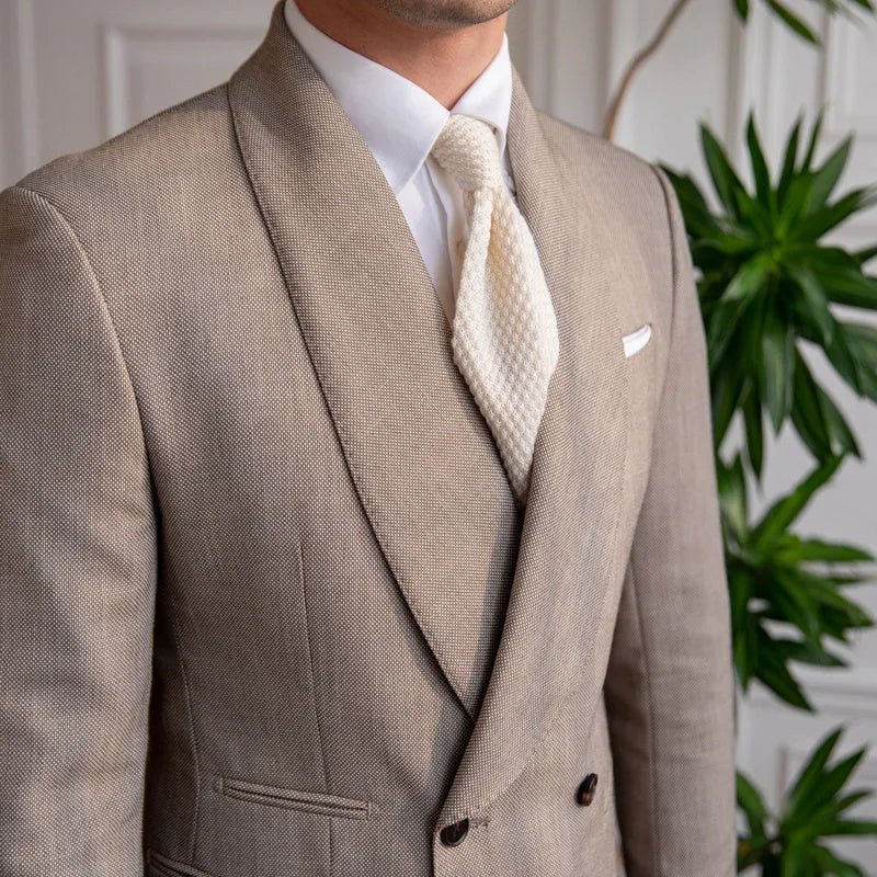 Men's light coffee double-breasted tuxedo suit jacket with notched lapels on a plain background