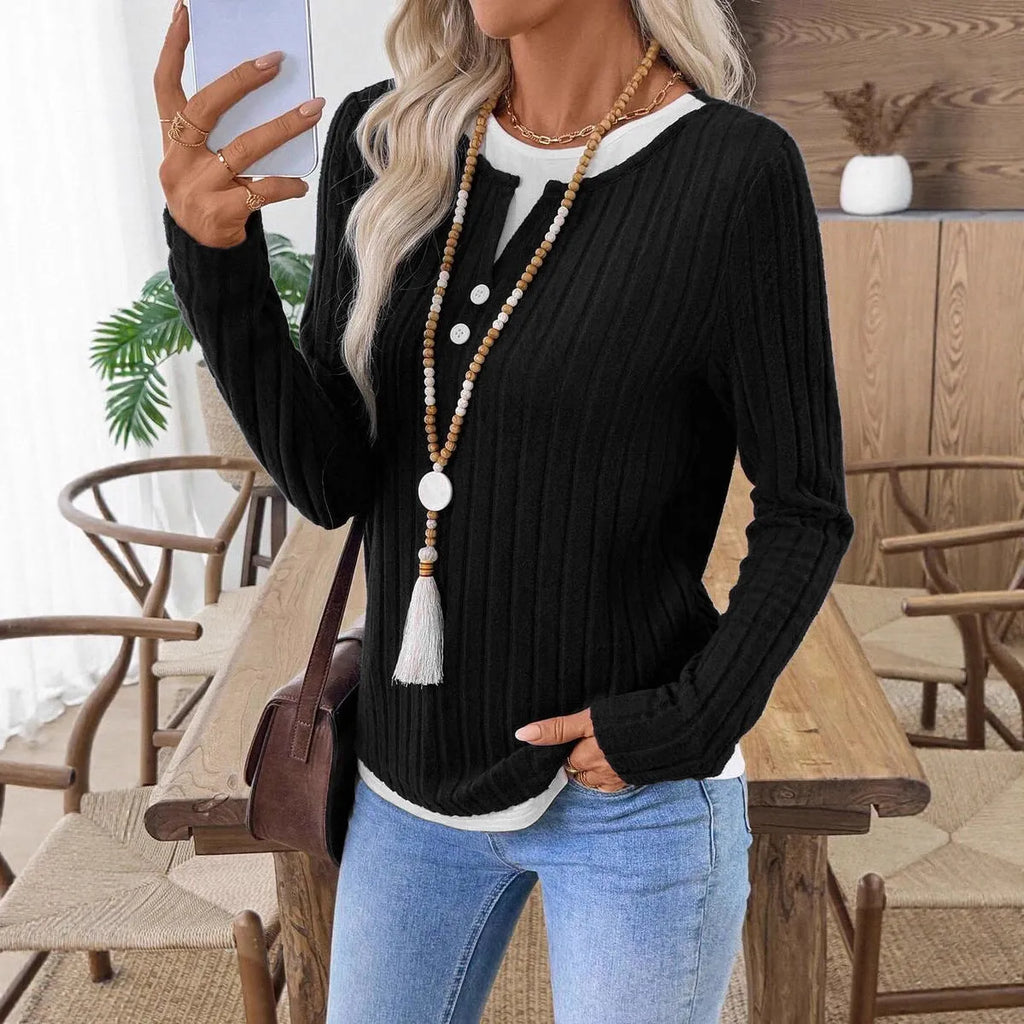Women's black concave stripe fake two-piece pullover sweater with long sleeves and round neck.