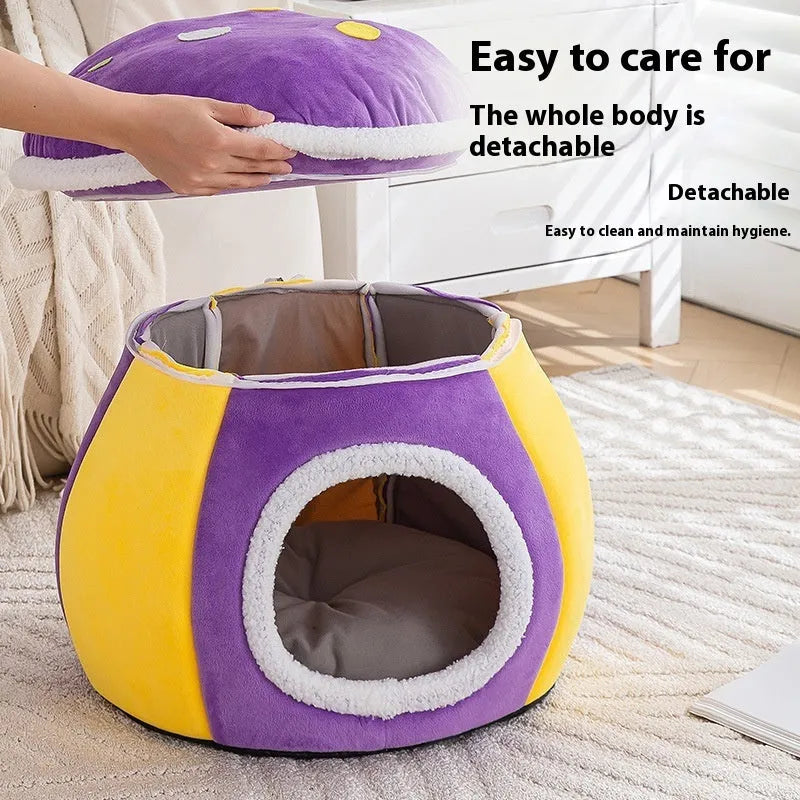 Grey mushroom-shaped enclosed cat bed with plush interior and a detached matching blanket on a wooden floor.