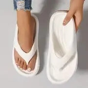 Women's black thick-soled EVA flip-flops with a non-slip sole design.