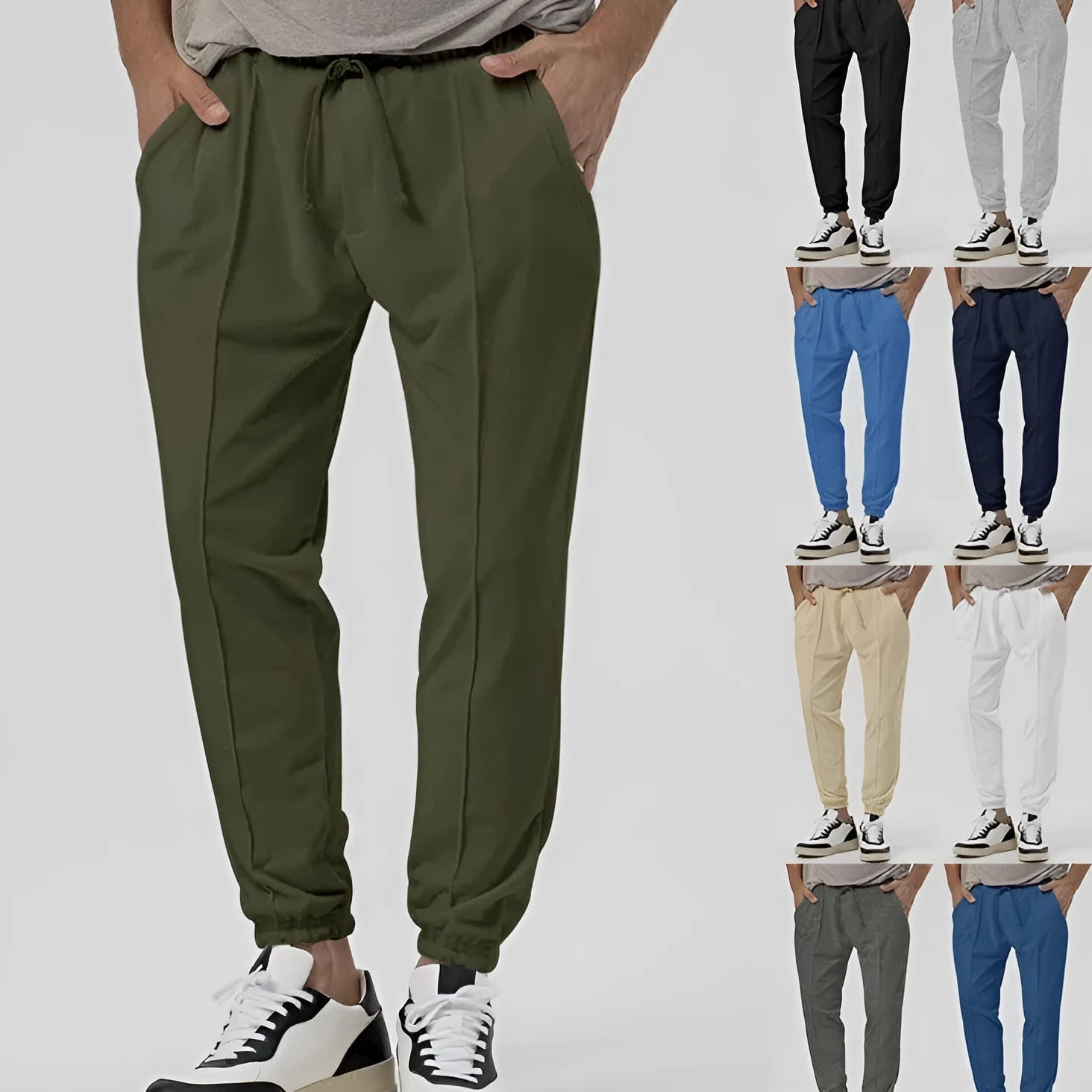 Man wearing grey loose tapered casual sweatpants with a straight leg and elasticated waistband.