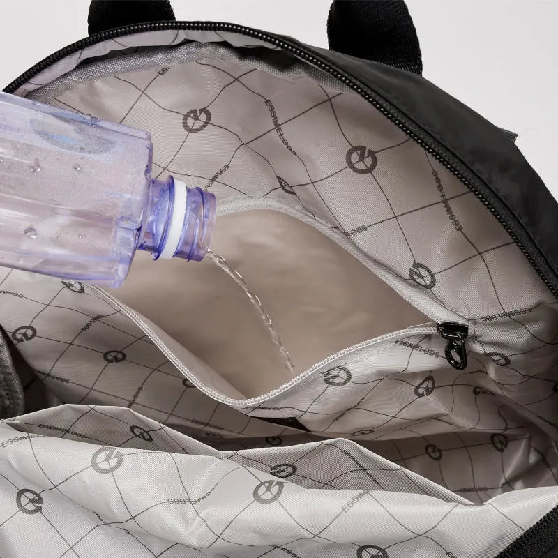 Large lightweight nylon backpack in black, shown with a sandwich pocket and main compartment.