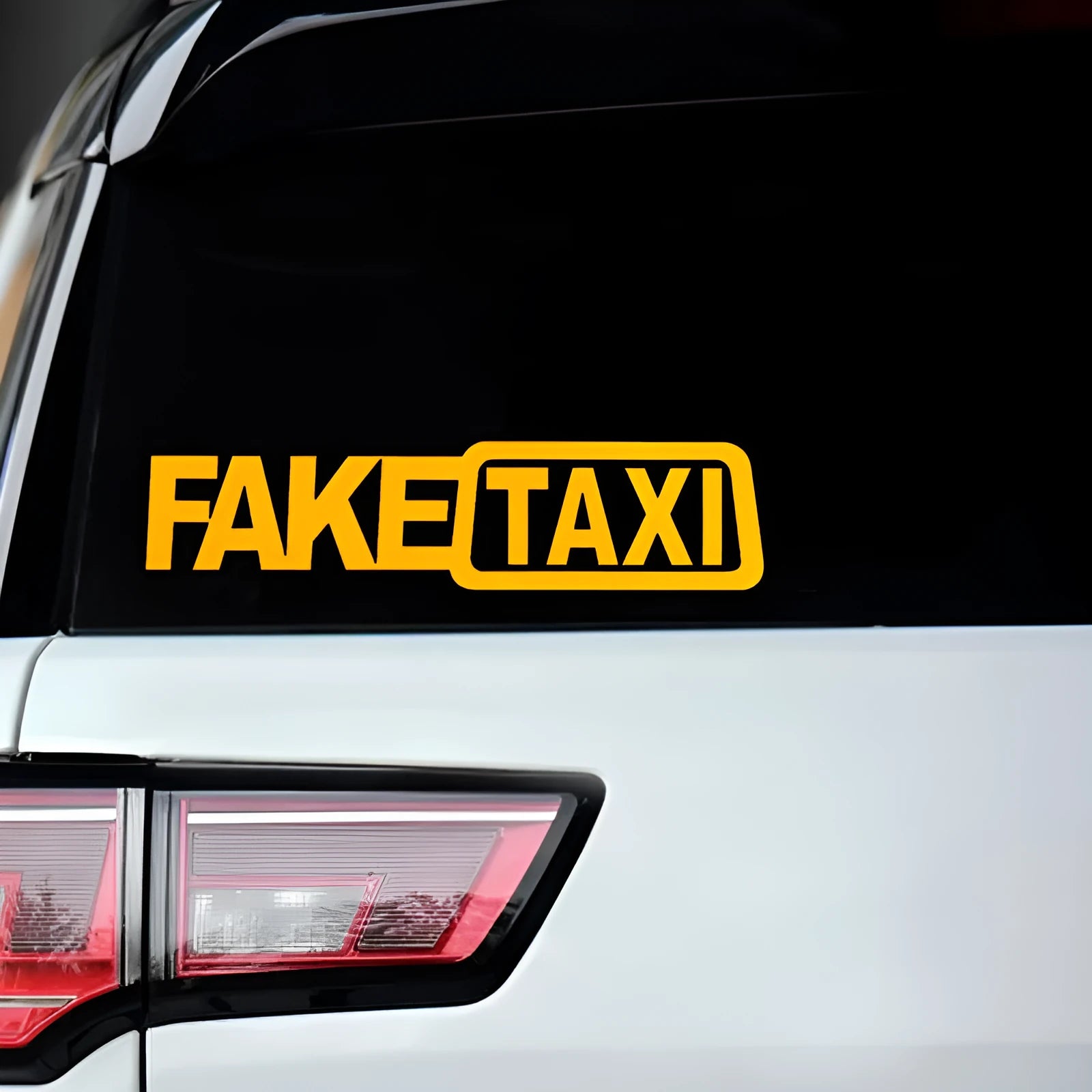 FAKE TAXI text car window sticker in yellow, 20cm by 8cm, made from waterproof PET material.