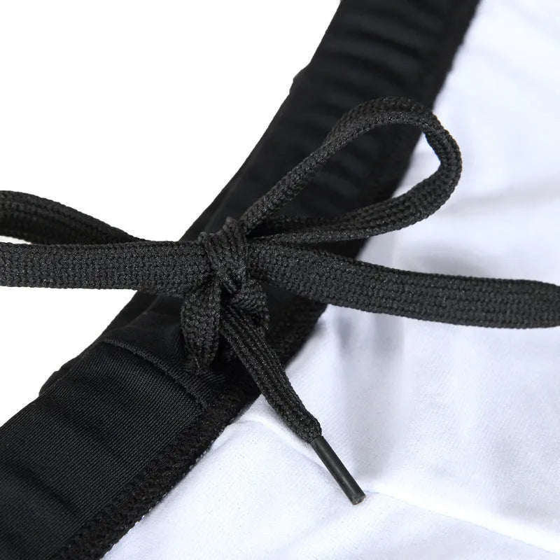Men's plus size swim trunks with flame pattern and matching swimming cap on a black background.