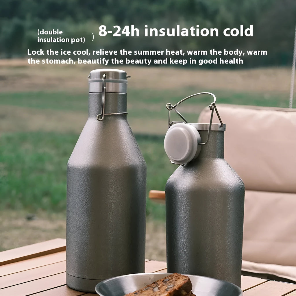 Large stainless steel outdoor thermal pot with a handle, shown in a natural setting.