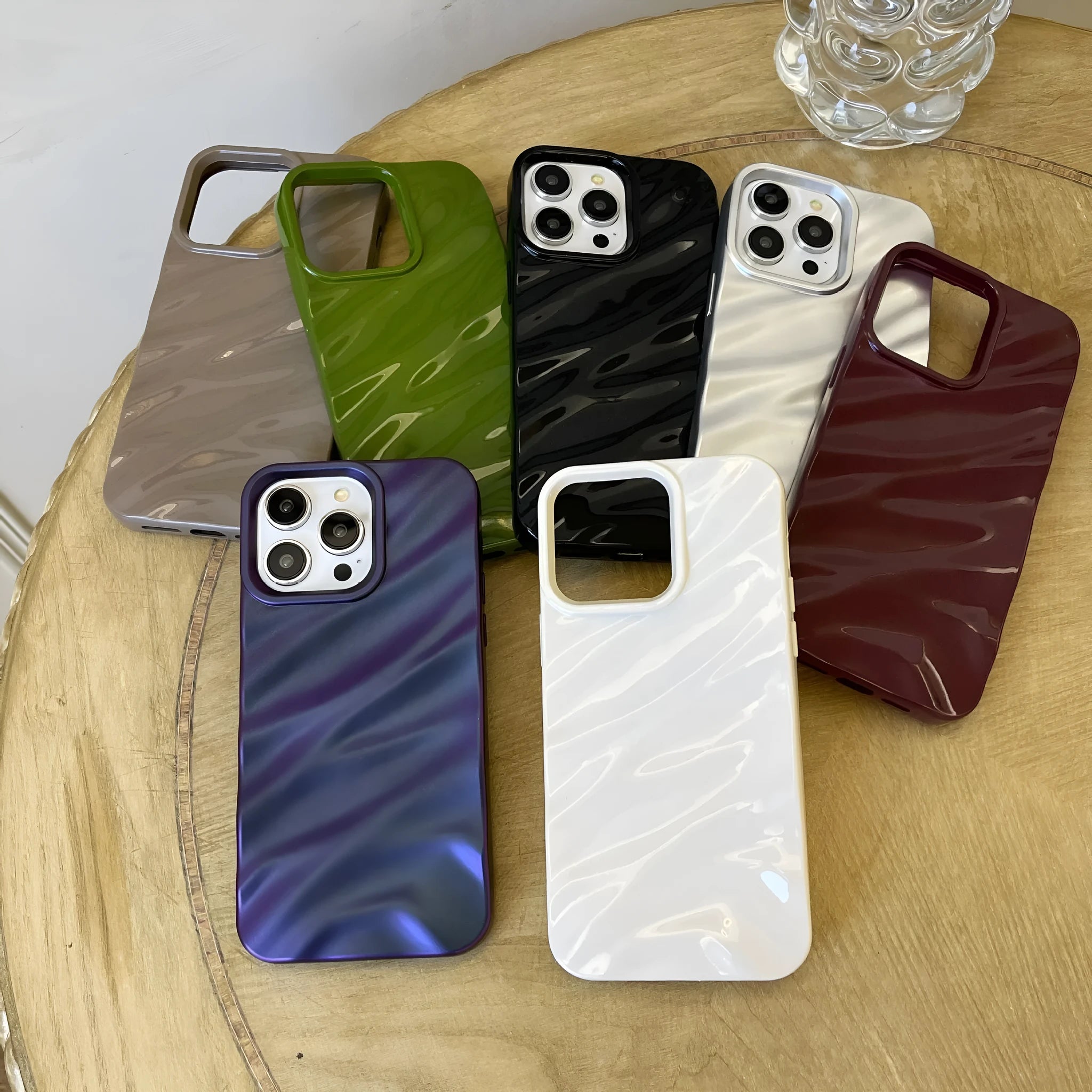 Soft wave-patterned TPU phone case for Apple iPhone 17 models in burgundy colour.