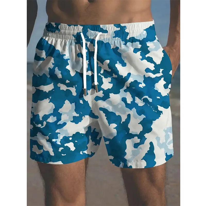 Man wearing coloured print polyester beach shorts with an elastic waistband for summer travel.