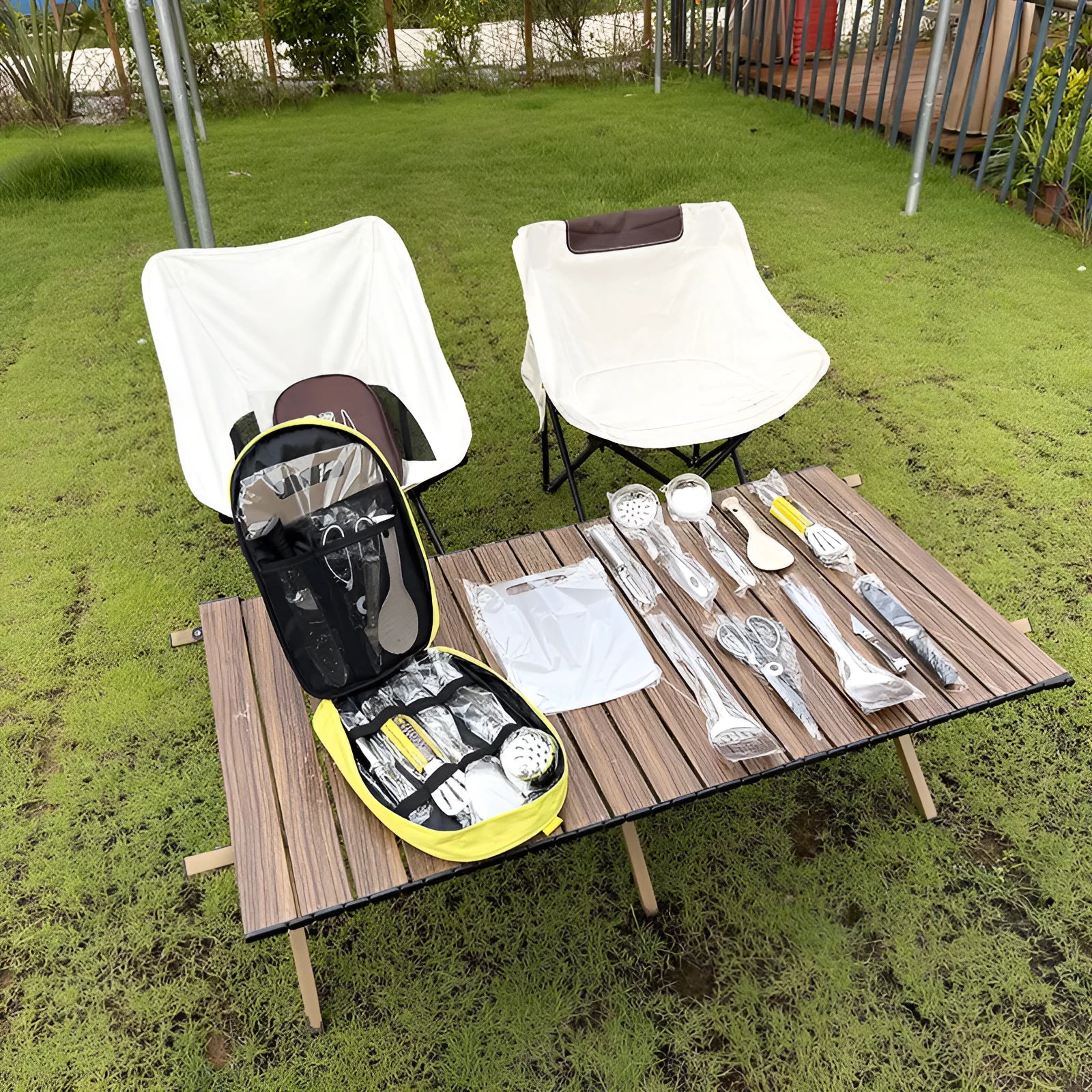 Portable storage bag containing a 12-piece stainless steel picnic cutlery set for outdoor use.