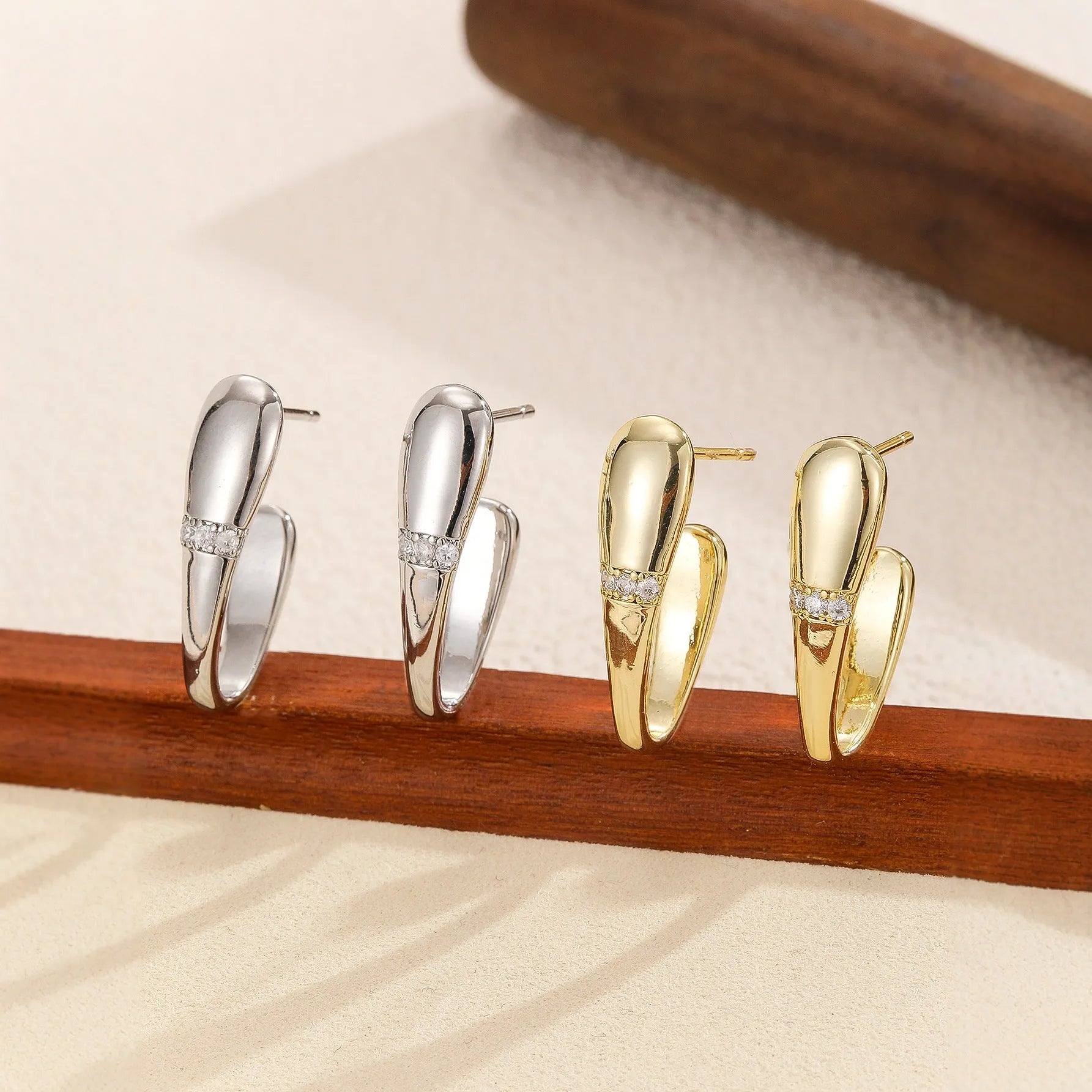 Simple square metal earrings in two styles on a clean background
