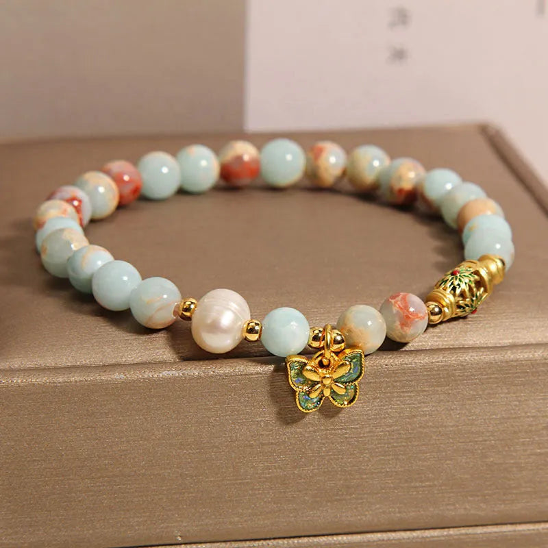 Blue freshwater pearl bracelet with Shoushan stone accents and detailed butterfly pendant