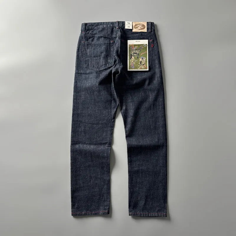 Man wearing blue straight leg denim jeans with a mid waist, showcasing the classic five-pocket retro design.