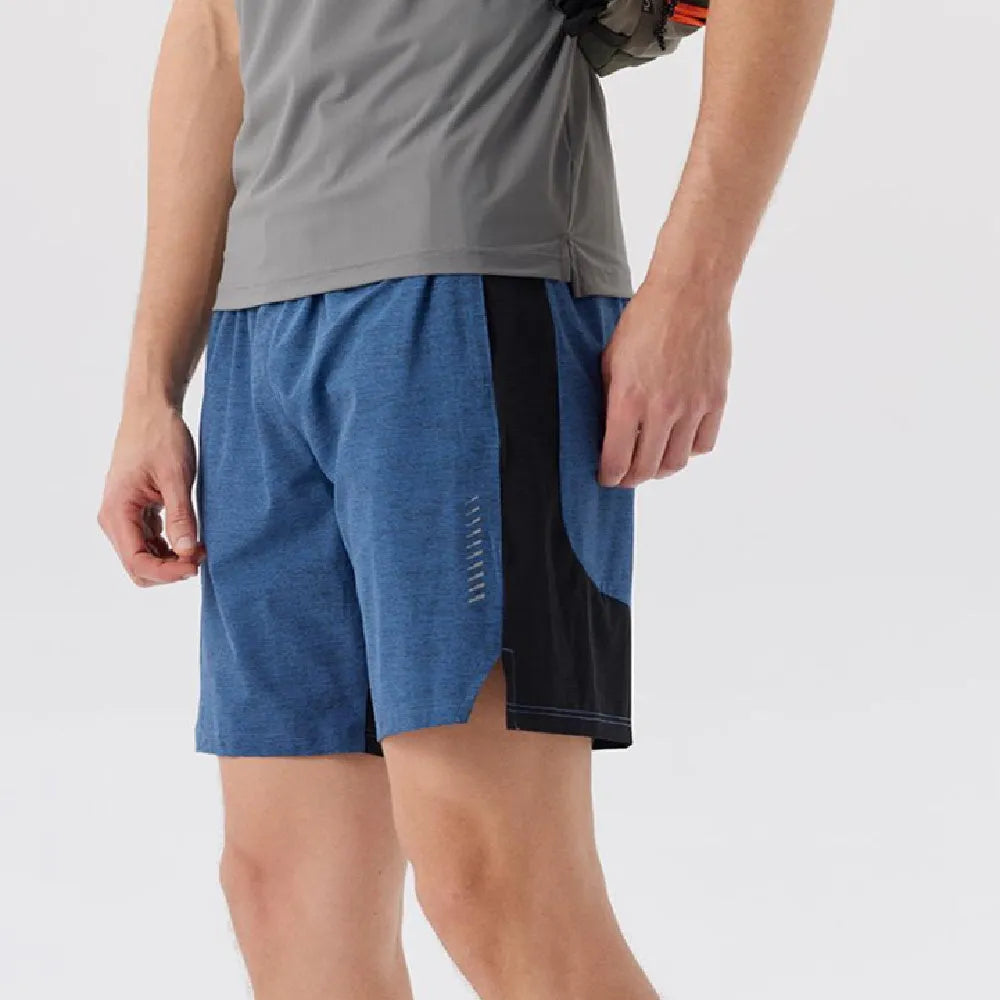 Man wearing forest green stretch spandex casual shorts with a mid-waist fit and shorts length.