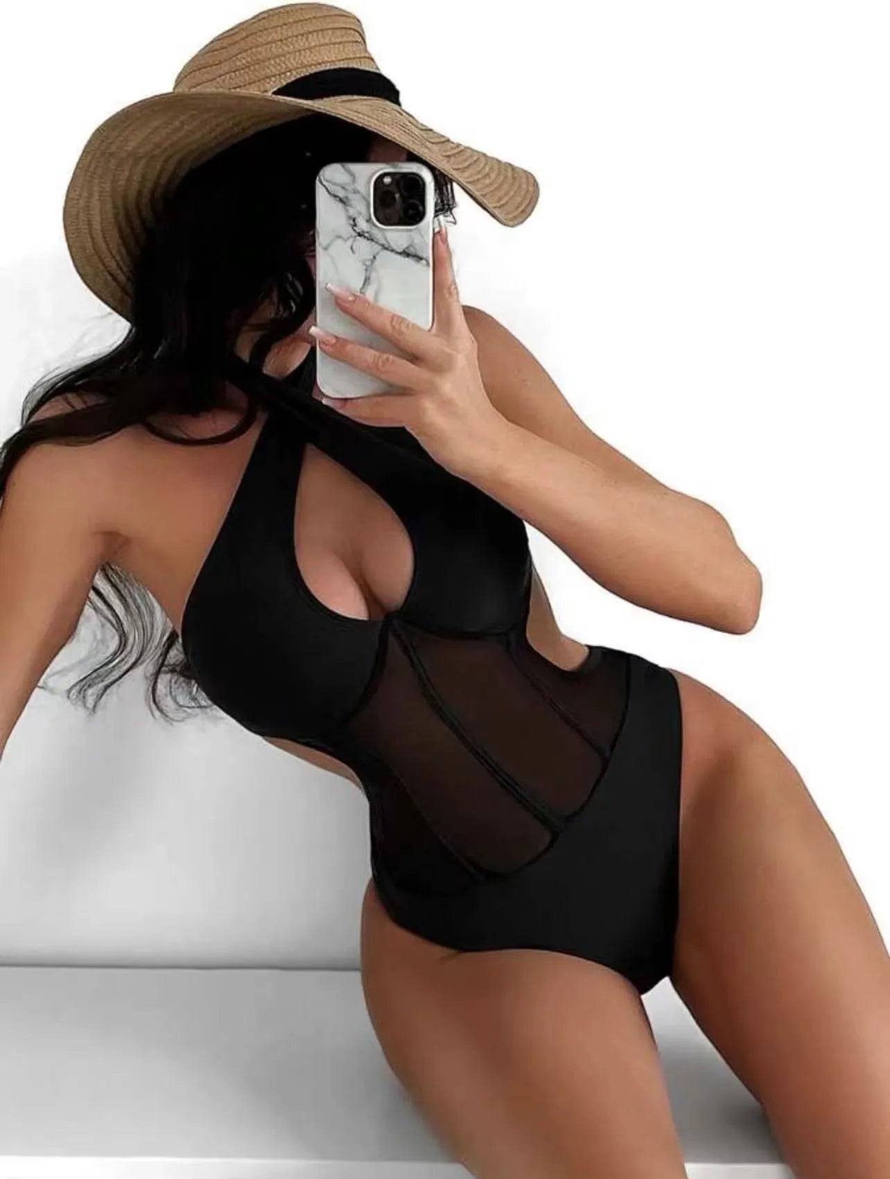 Women's black one-piece nylon swimsuit laid flat, showing its style and material.