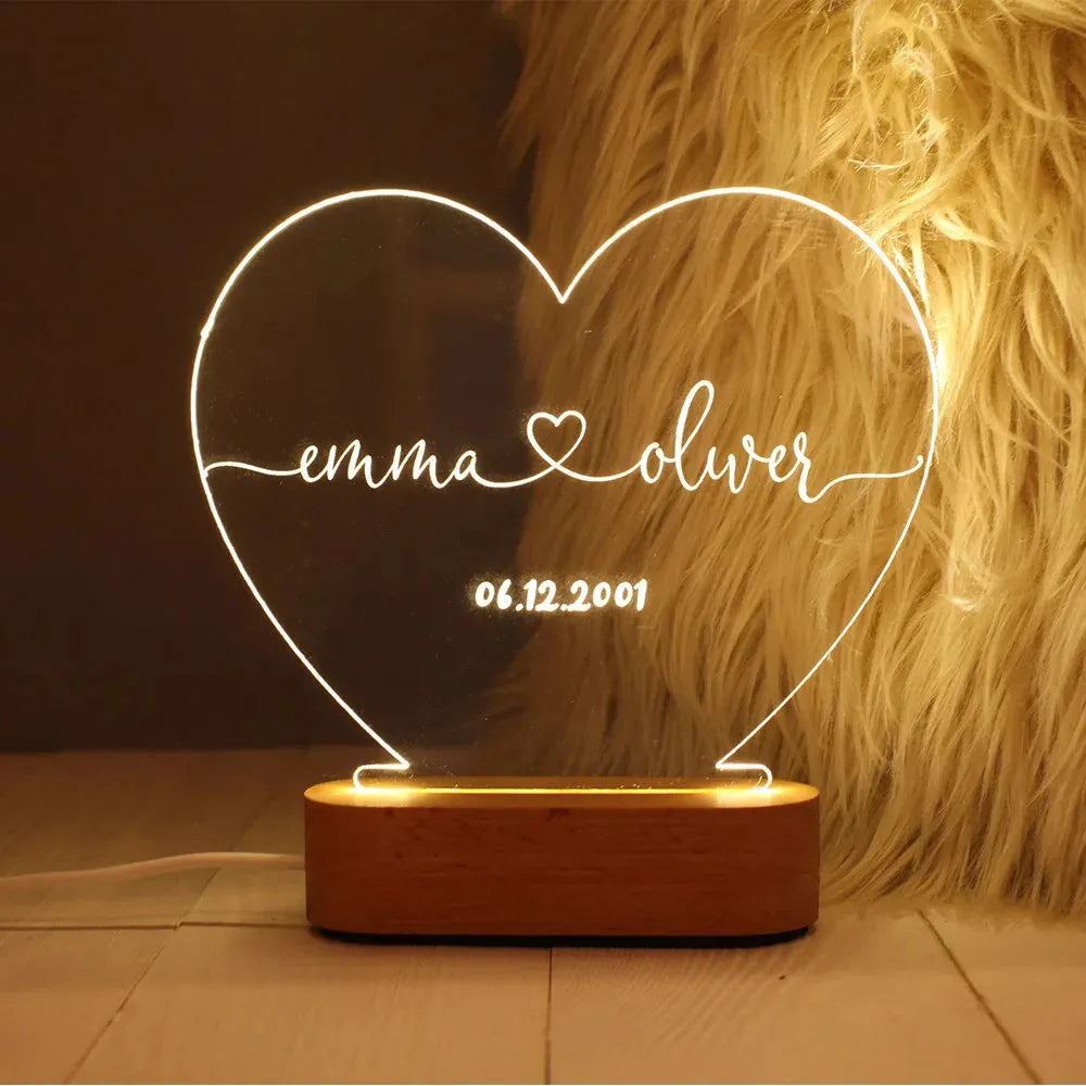 Custom engraved acrylic night light with names and date, illuminated by an LED base.