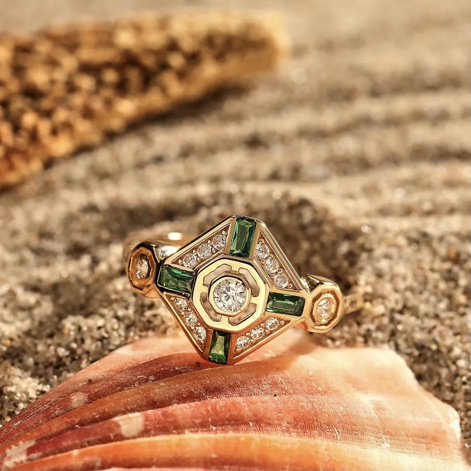 Square emerald-coloured gemstone ring for women on a plain background.