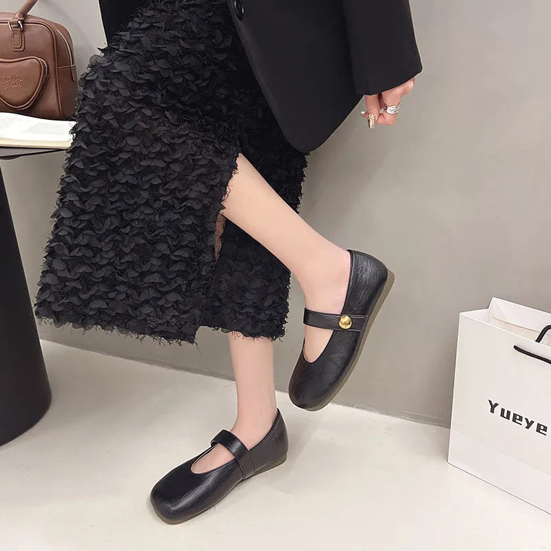 Women's casual flat heel buckle pumps in black with round toe and belt buckle detail