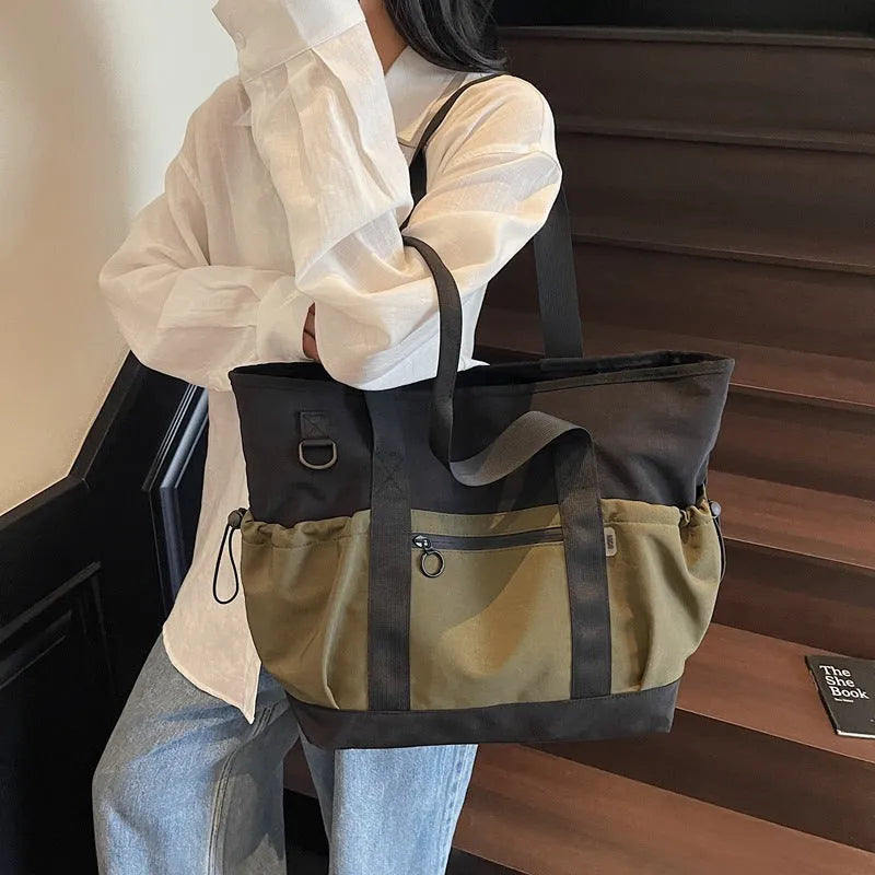 Lightweight Oxford cloth duffel bag for women in grey, shown with a yoga mat.