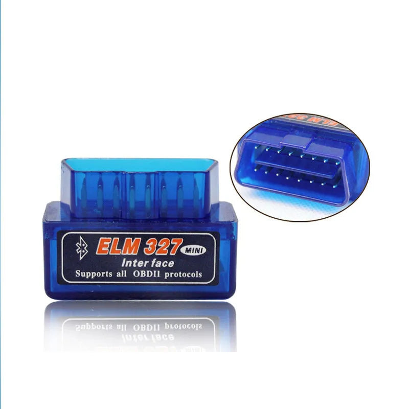 Small black OBD2 Bluetooth scanner car diagnostic code reader next to a vehicle's diagnostic port.