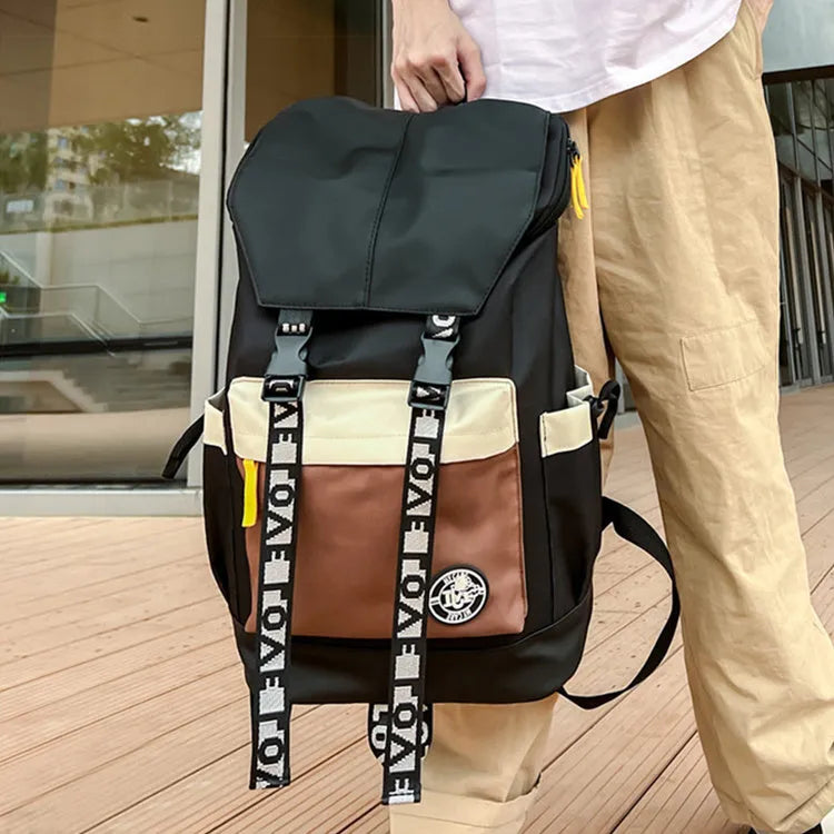 Oxford cloth backpack in black shown with handheld grip and shoulder straps.