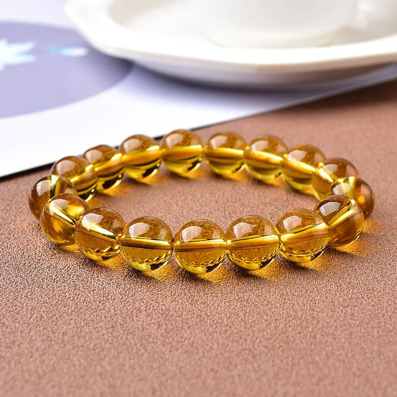 Geometric glass bead bracelet in obsidian, amethyst, citrine, or white crystal on a white background.