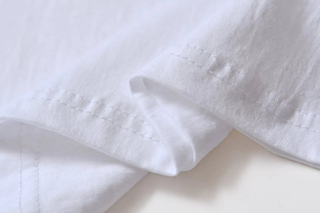 White cotton t-shirt overalls with round neck and short sleeves in loose fit