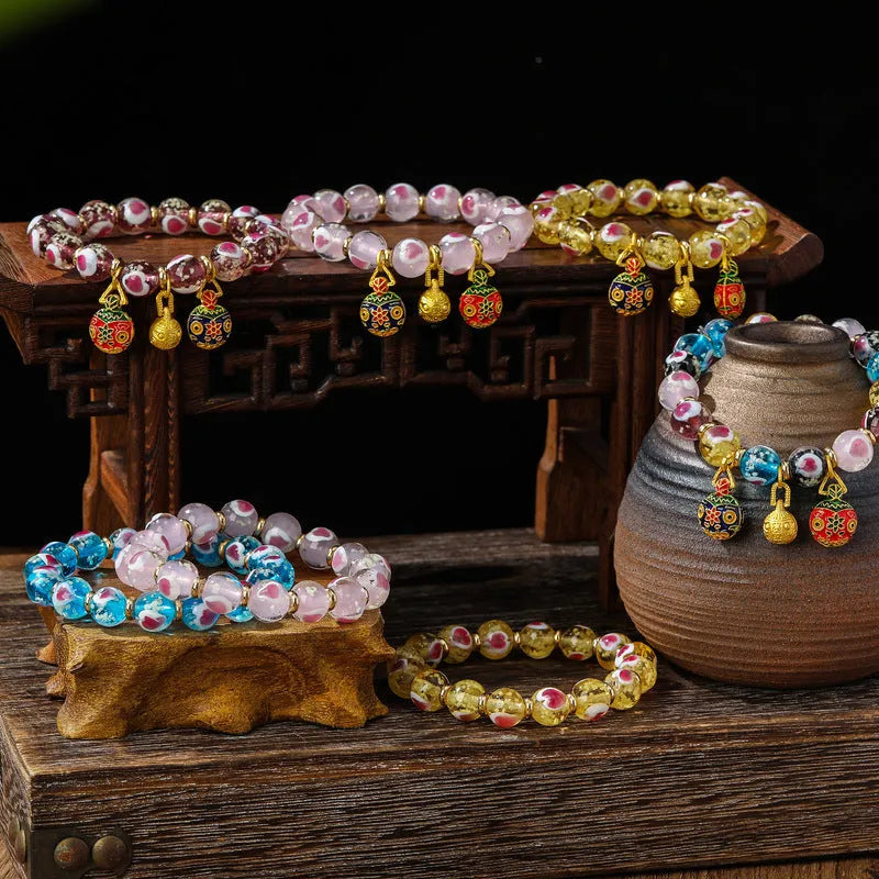 Handmade glass bracelet with swallowing gold beast charm and heart-shaped fluorescent glaze beads