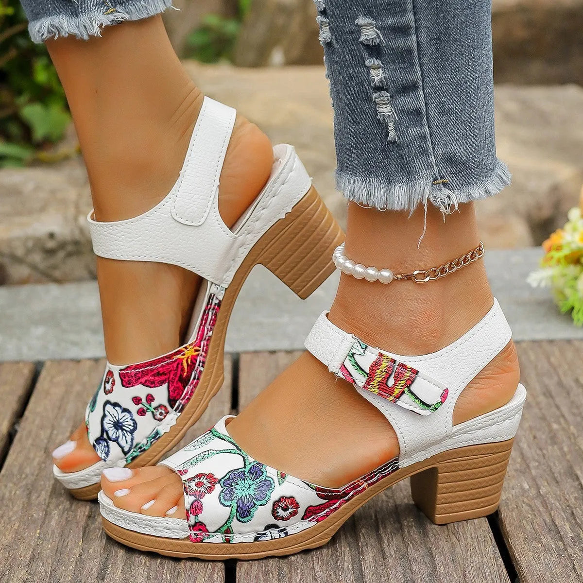 White women's high heel sandals with a Velcro strap buckle on a casual rubber sole.