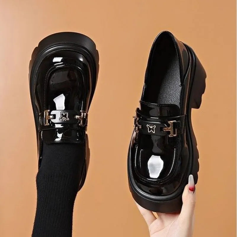 Black slip-on shoes with chunky square heel, round toe, and skull pattern on EVA upper