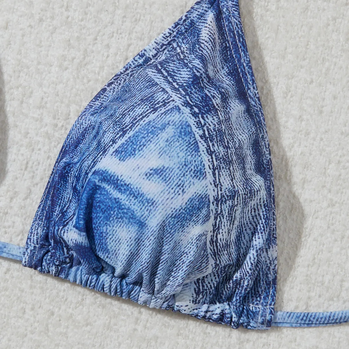 Denim blue printed bikini top and bottom set for women on a mannequin.