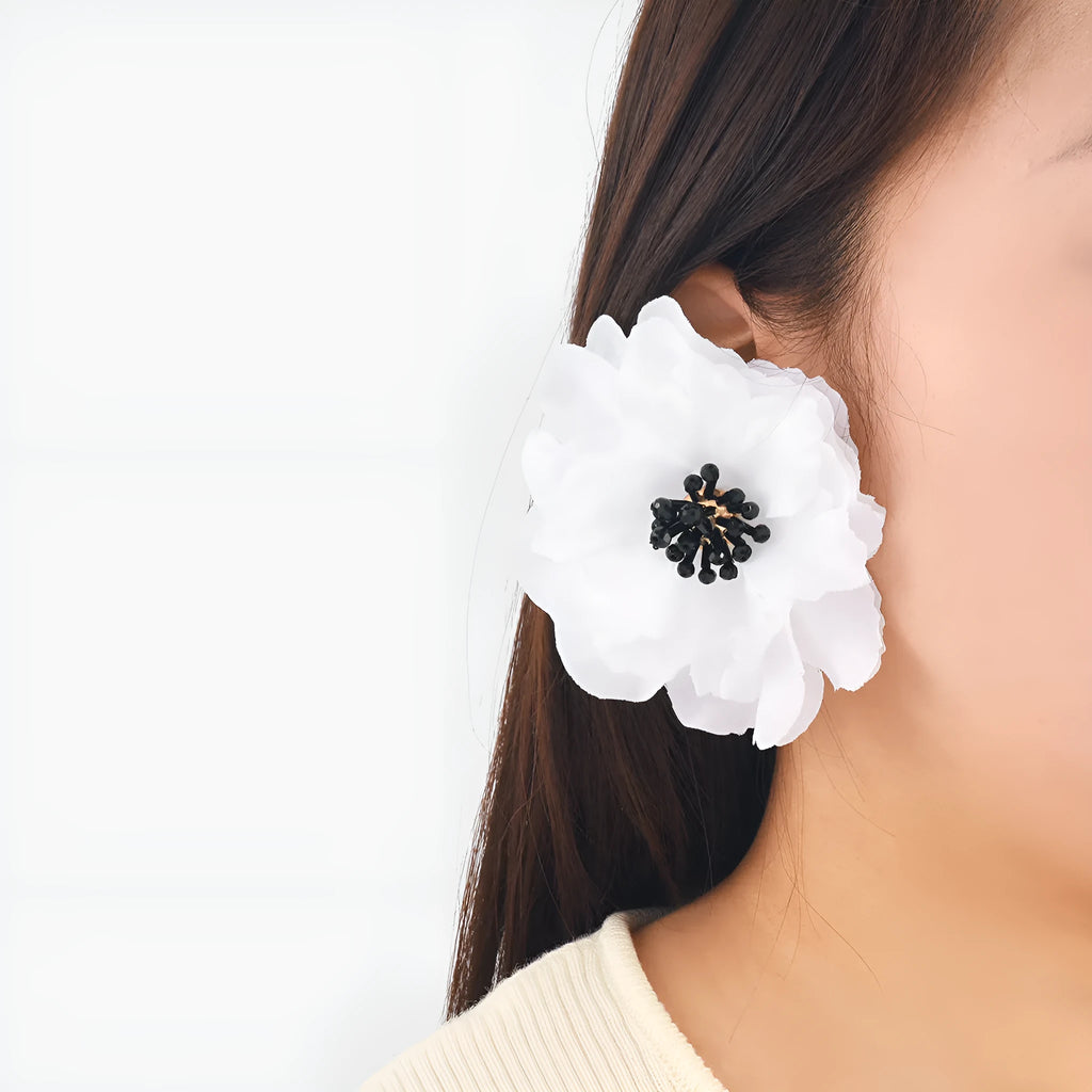Hand-woven white plastic resin flower earrings for women fashion OL style on display