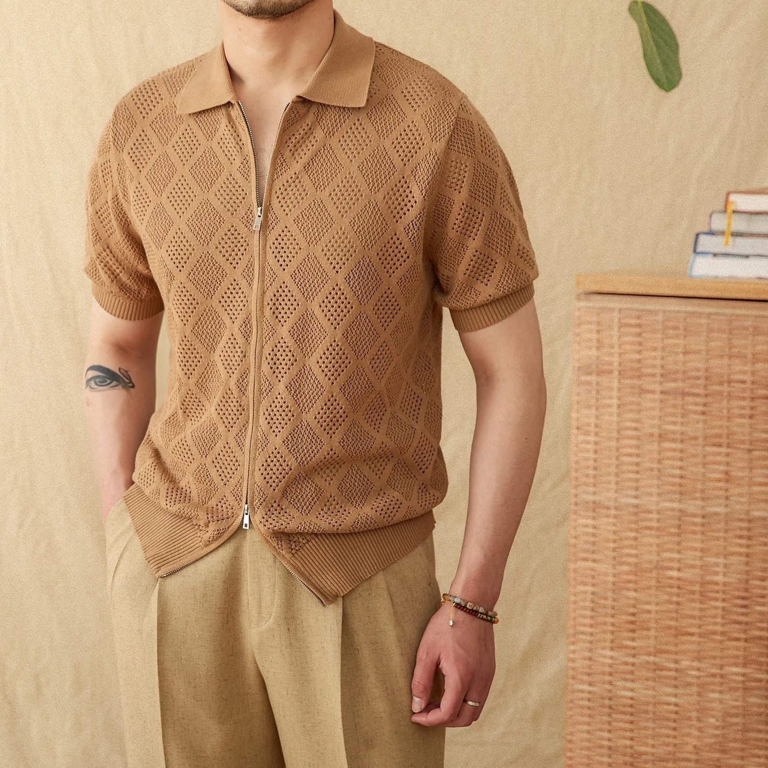 Light brown cotton short sleeve cardigan with a front zipper and lapel collar on a hanger.
