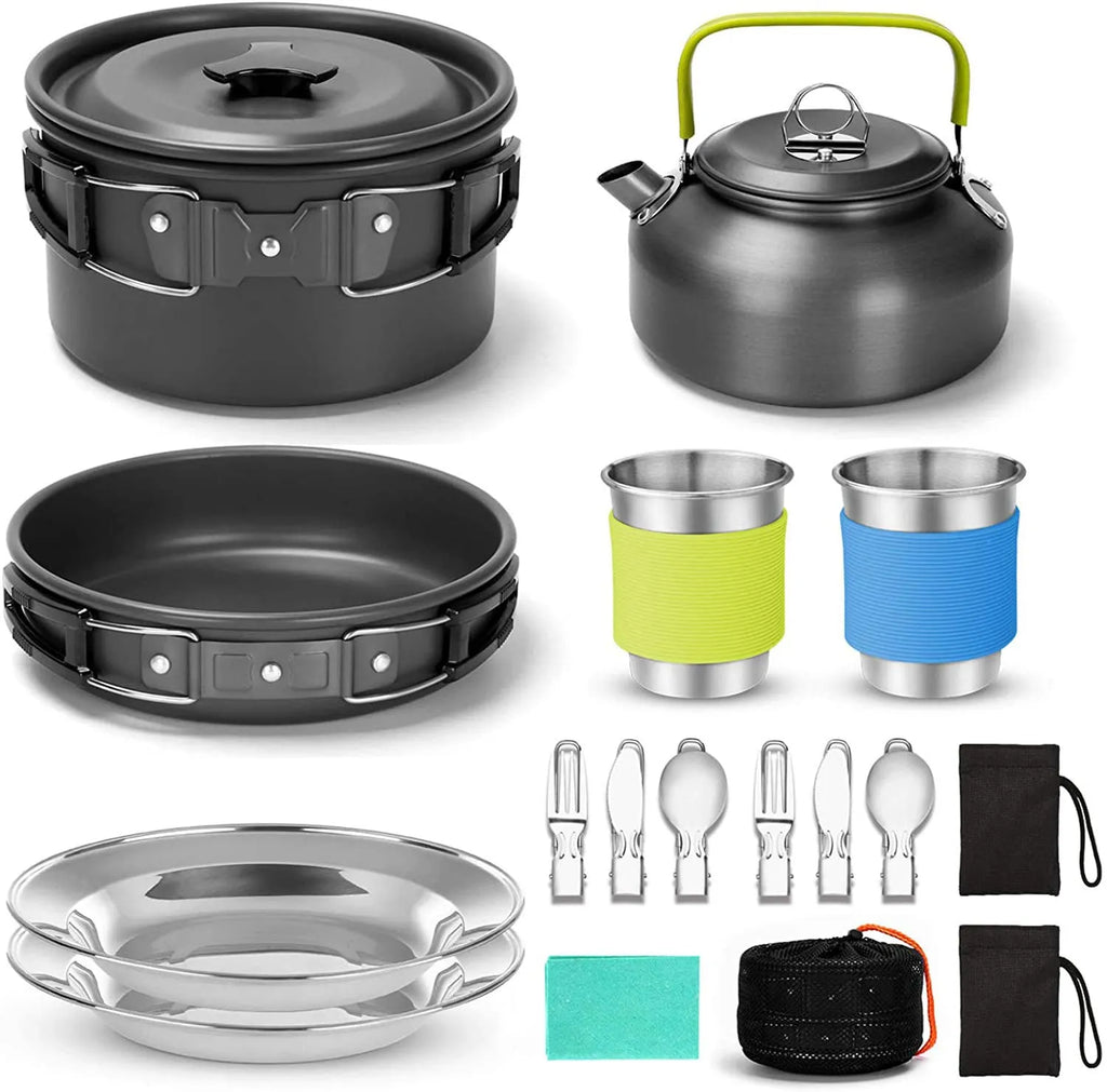 Camping cooker set with hard aluminium boiling pan, frying pan, teapot, stainless steel cutlery, cups, and plates on outdoor table