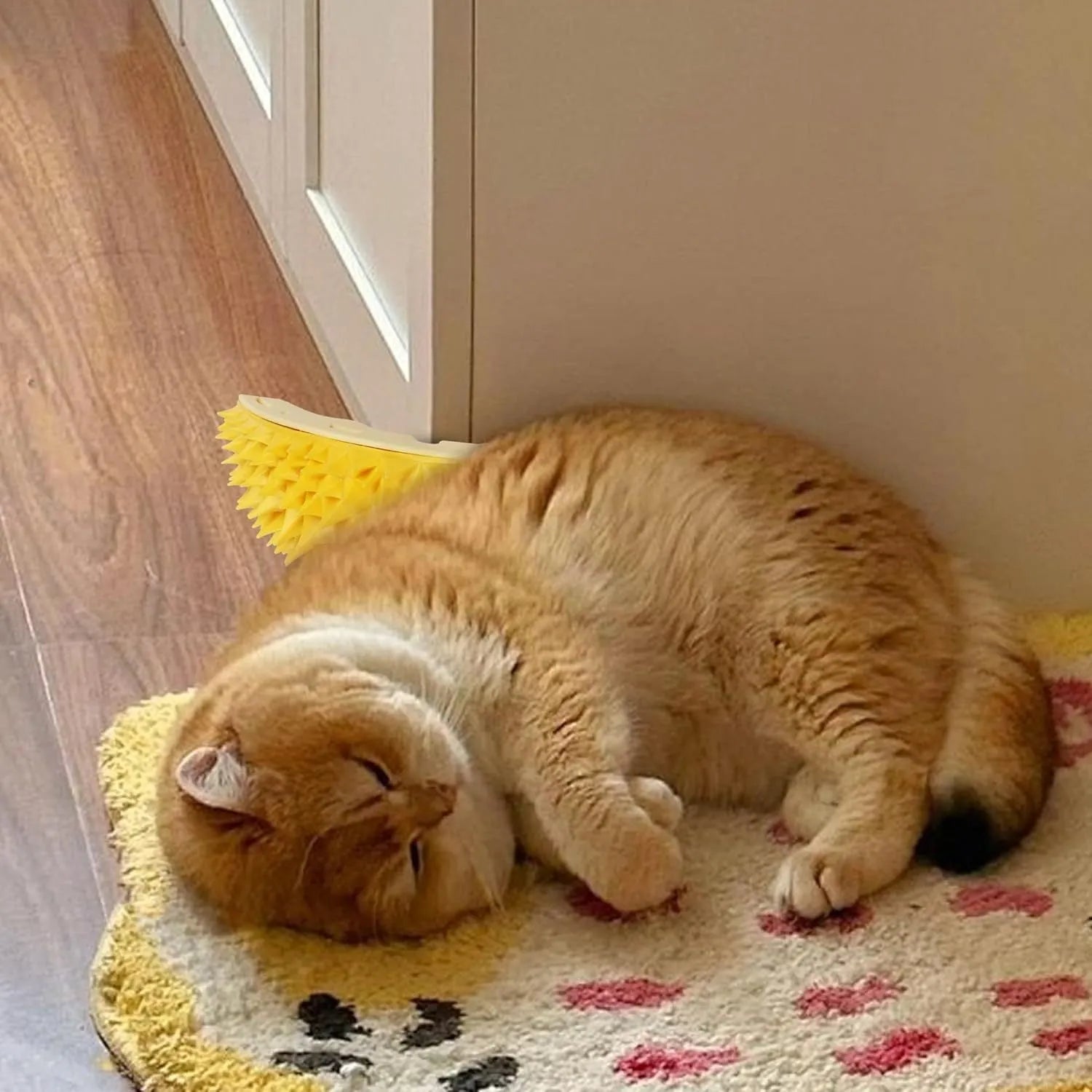 Yellow durian-shaped cat corner scratcher and self-groomer mounted on a wall
