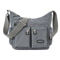 Women's waterproof nylon crossbody shoulder bag in black with multiple pockets and telescopic handle