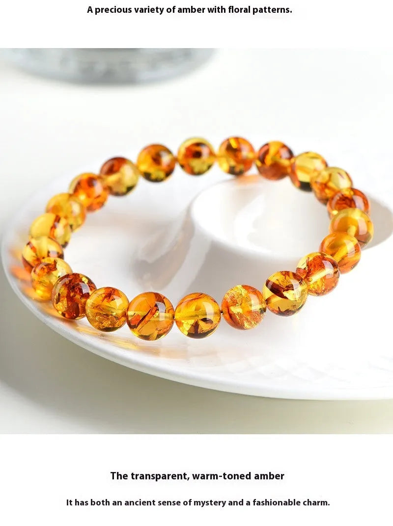 Natural yellow piebald amber bracelet with geometric design on a wrist.
