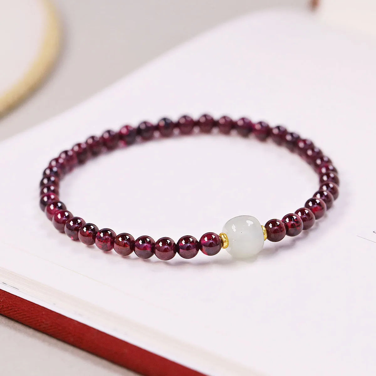 Women's garnet bracelet with U-shaped design and polished stones in 4mm or 6mm diameters