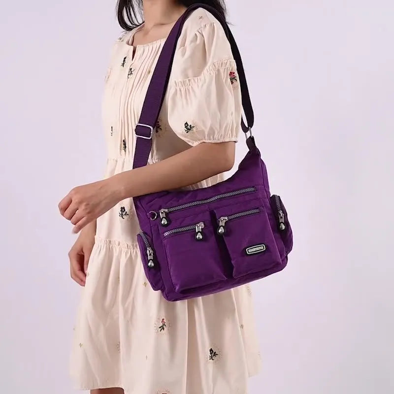 Women's waterproof nylon crossbody shoulder bag in black with multiple pockets and telescopic handle