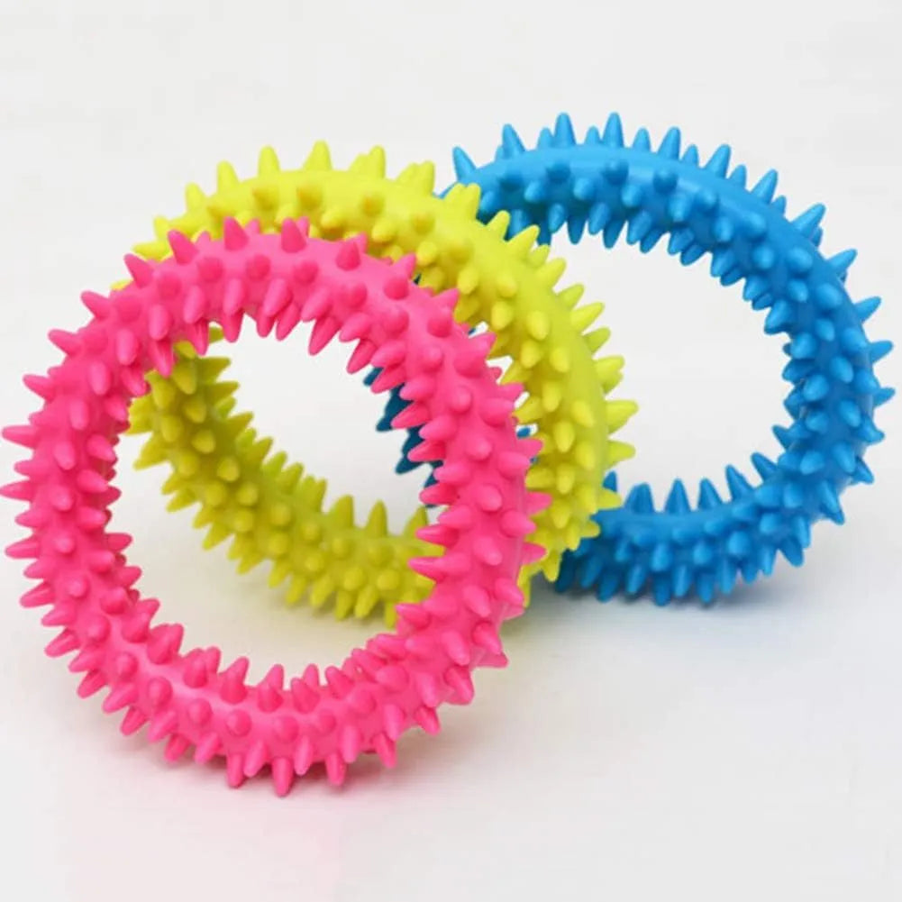 Blue TPR spiky circle ring dog chew toy for teeth cleaning on a white background.
