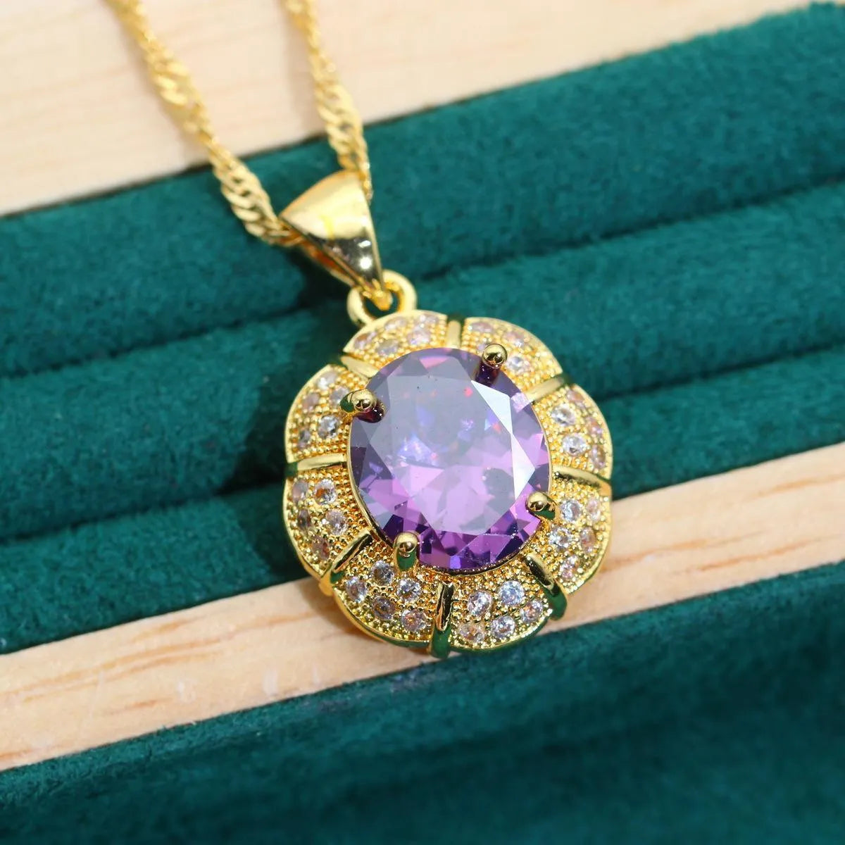 An 18k gold plated jewellery set featuring a necklace, earrings, a ring, and a bracelet with coloured cubic zirconia stones.
