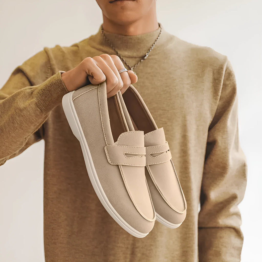 Men's beige suede British style casual slip-on shoes with a round toe and low flat heel on a rubber sole.