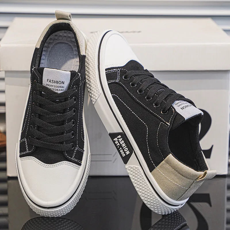 Men's blue low-top canvas casual sneakers with round toe and lace-up front on a white background.