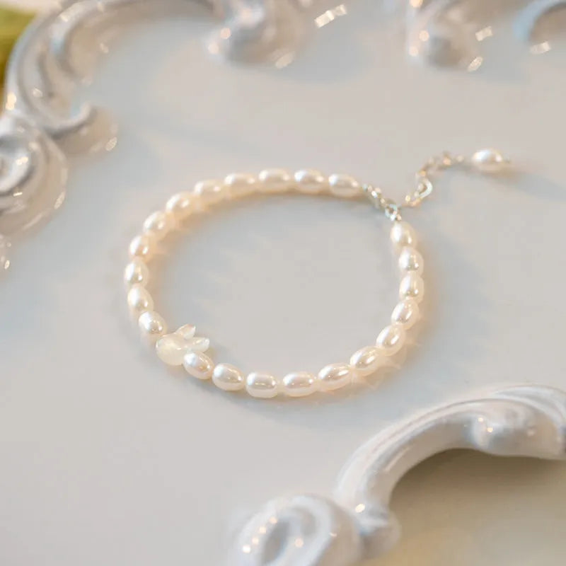 Handmade women's rabbit bracelet with 925 silver charm and white shell pearl beads on elastic string