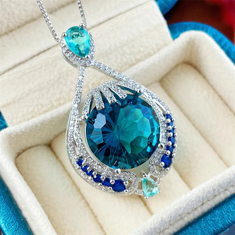 Women's geometric necklace with fireworks-cut blue gem pendant on water wave chain