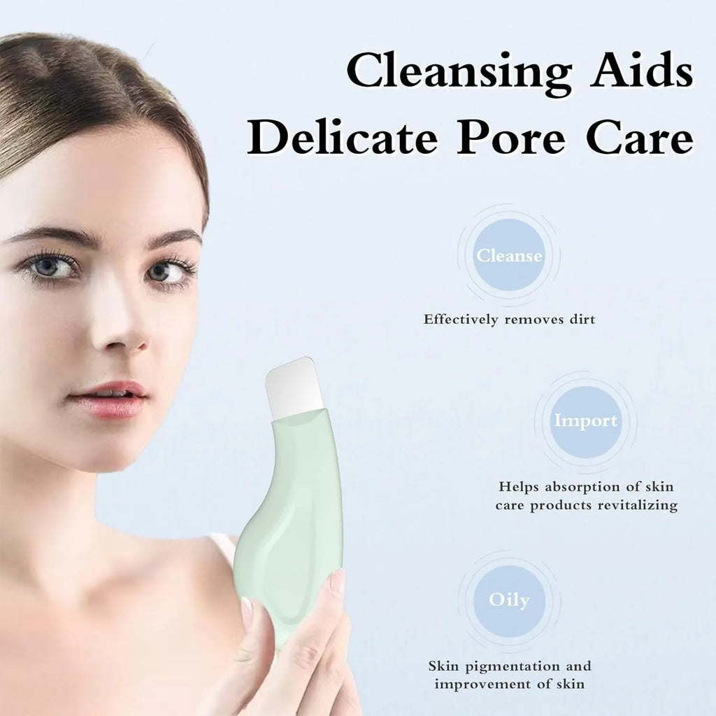 Stainless steel pore scraper face tool with a green silicone non-slip handle.