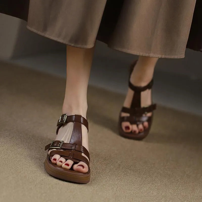 Women's black retro sandals with a chunky heel, platform, and T-shaped buckle fastening.